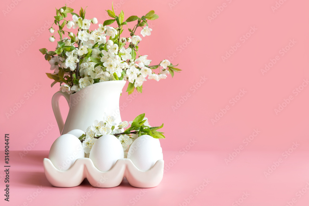 Bouquet of spring flowers in vase and eggs on pink table. Space for text.