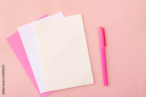 Bilde på lerret Colored blank sheets of pastel colors on a pink background next to the pen