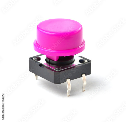 Small electronic tactile toggle push button switch with purple hat isolated on white background.