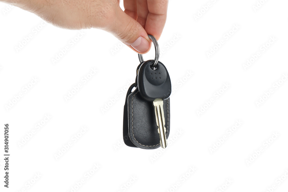 Man holding key on white background, closeup. Car buying Man holding key on white background, closeup. Car buying