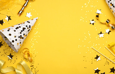 Flat lay composition with birthday decor on yellow background. Space for text