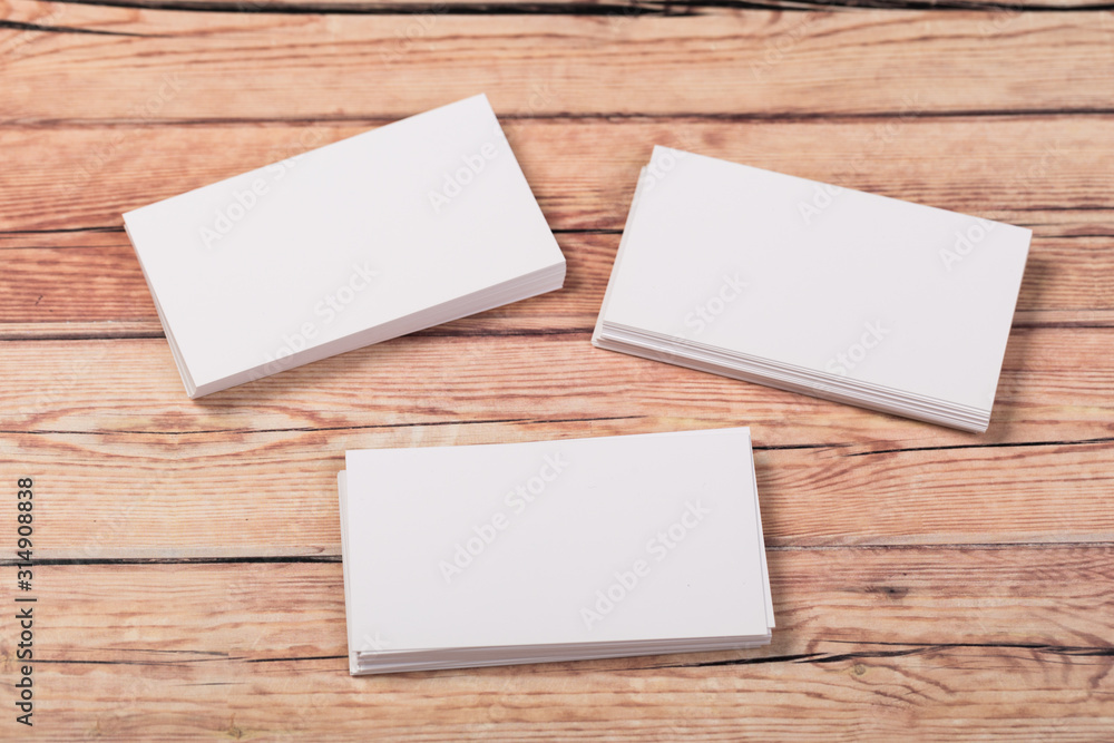 Photo of empty business cards on a light natural wooden background .. Template for identifier. Photo of empty business cards on a light natural wooden background .. Template for identifier.