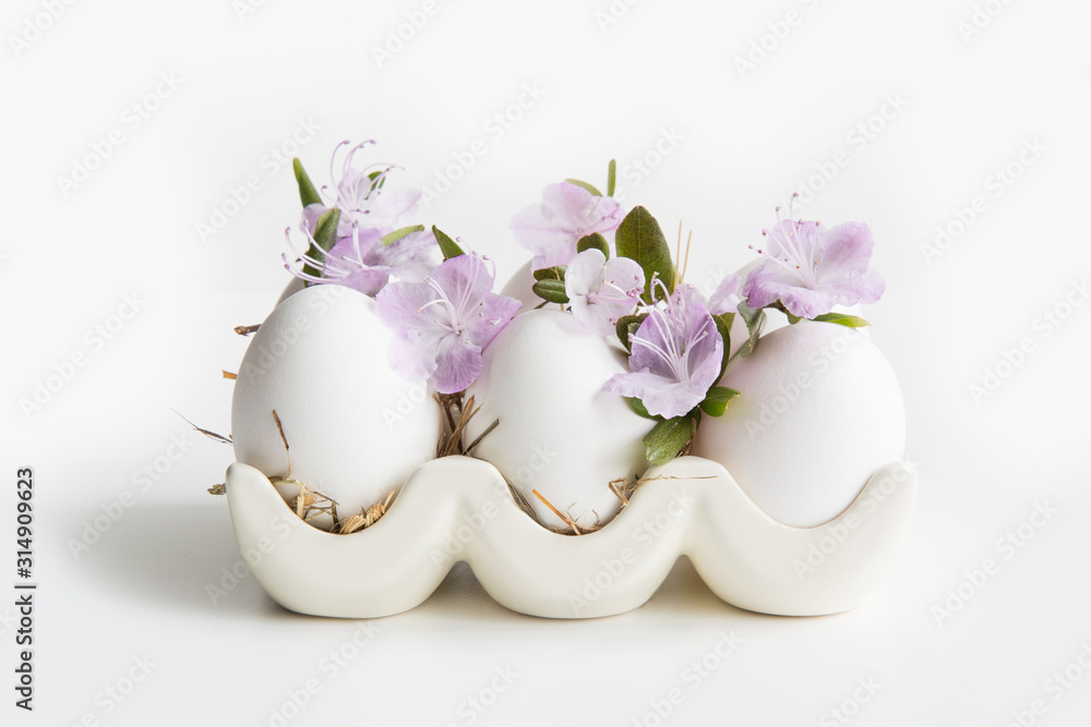 Organic white chicken eggs with spring flowers in porcelain box. Easter. Organic white chicken eggs with spring flowers in porcelain box. Easter.