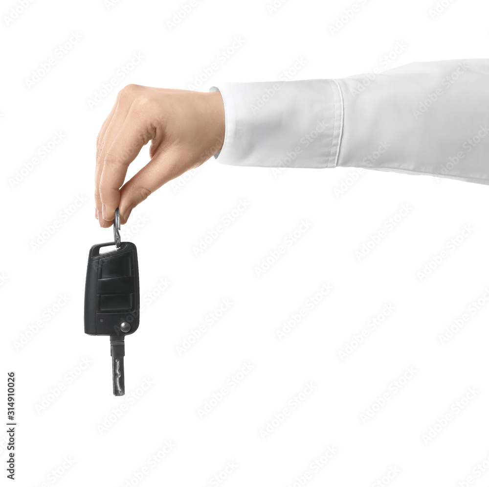 Man holding key on white background, closeup. Car buying Man holding key on white background, closeup. Car buying