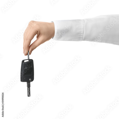Man holding key on white background, closeup. Car buying © New Africa