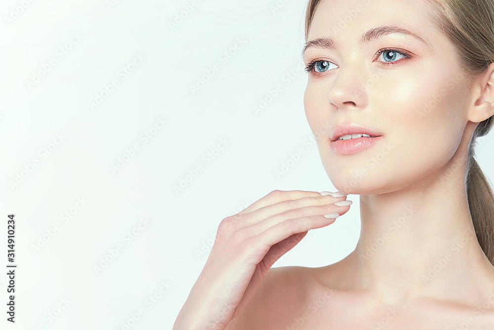 Beautiful young woman with clean perfect skin. Portrait of beauty model with natural nude make up and touching her face. Spa, skincare and wellness. Close up, copyspace Beautiful young woman with clean perfect skin. Portrait of beauty model with natural nude make up and touching her face. Spa, skincare and wellness. Close up, copyspace