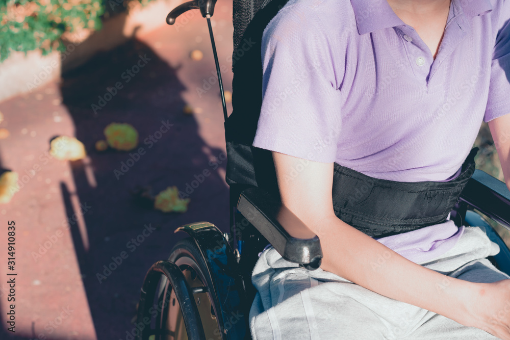 Obraz premium Disabled child on wheelchair is playing, learning and exercise in the outdoor city park like other people,Lifestyle of special child,Life in the education age of children,Happy disability kid concept.