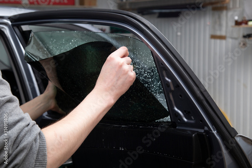Fotografie Installation of window film on car Windows