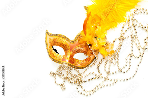 Fototapeta Naklejka Na Ścianę i Meble -  Golden Carnival mask on white background with silver beads. Mardi Gras concept. Copy space