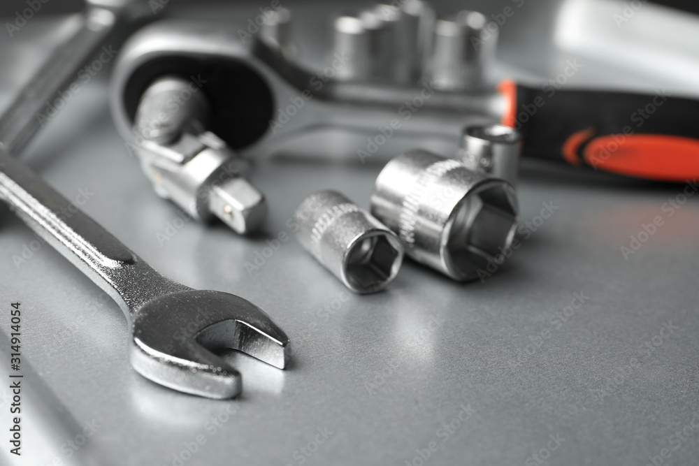 Auto mechanic's tools on metallic surface, closeup Auto mechanic's tools on metallic surface, closeup