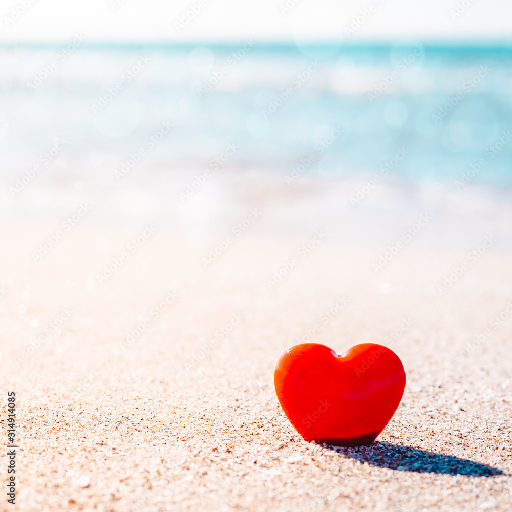 Romantic symbol of red heart on the sand beach Romantic symbol of red heart on the sand beach