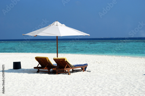 Sunbeds on white sand beach