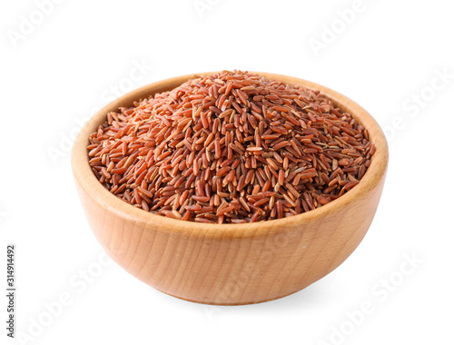 Brown rice in wooden bowl isolated on white