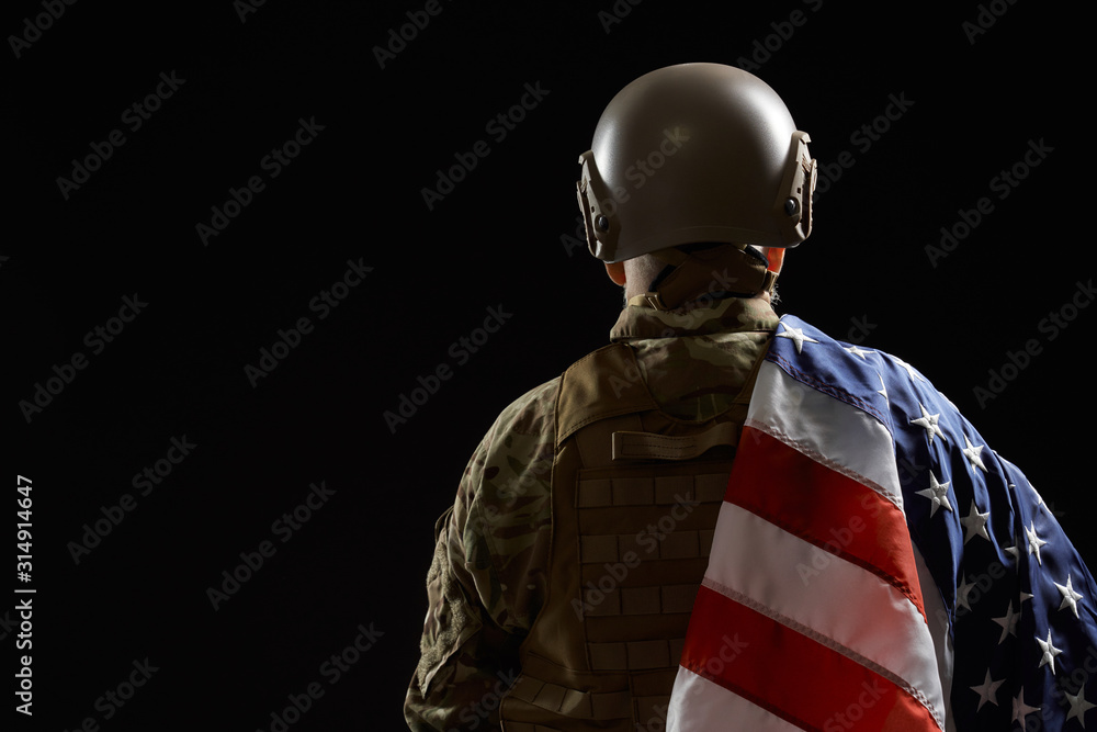 Back view of american veteran with flag on shoulder. Back view of american veteran with flag on shoulder.
