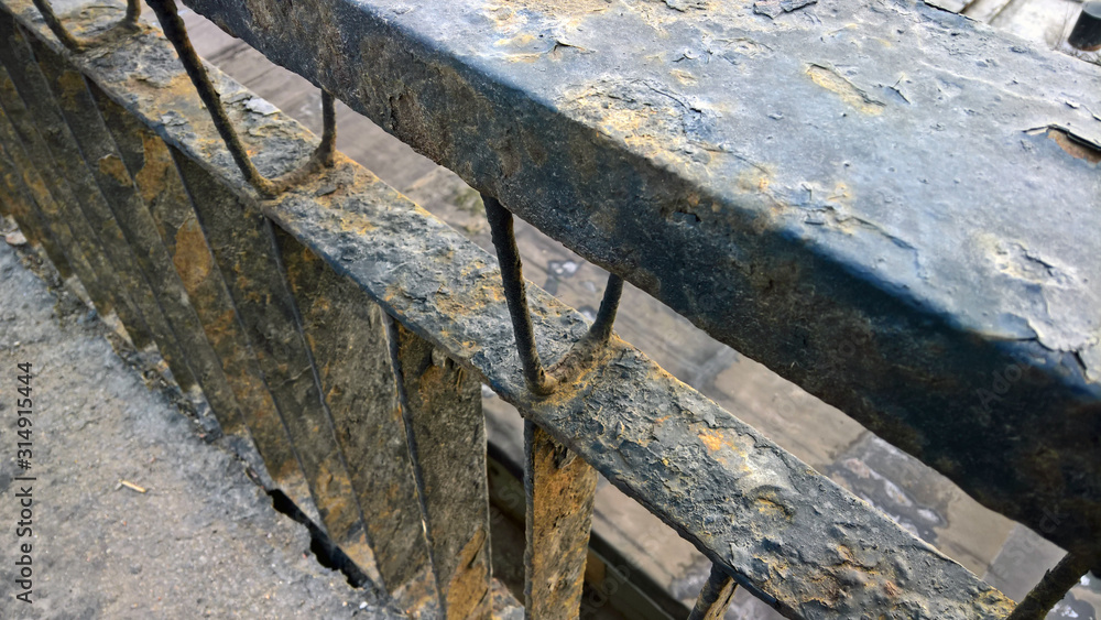yellow rust on metal railing. black paint yellow rust on metal railing. black paint