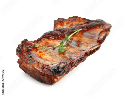 Tasty grilled ribs with thyme isolated on white