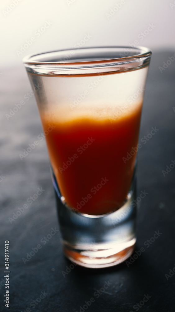 Vodka with tomato juice on a dark background Vodka with tomato juice on a dark background