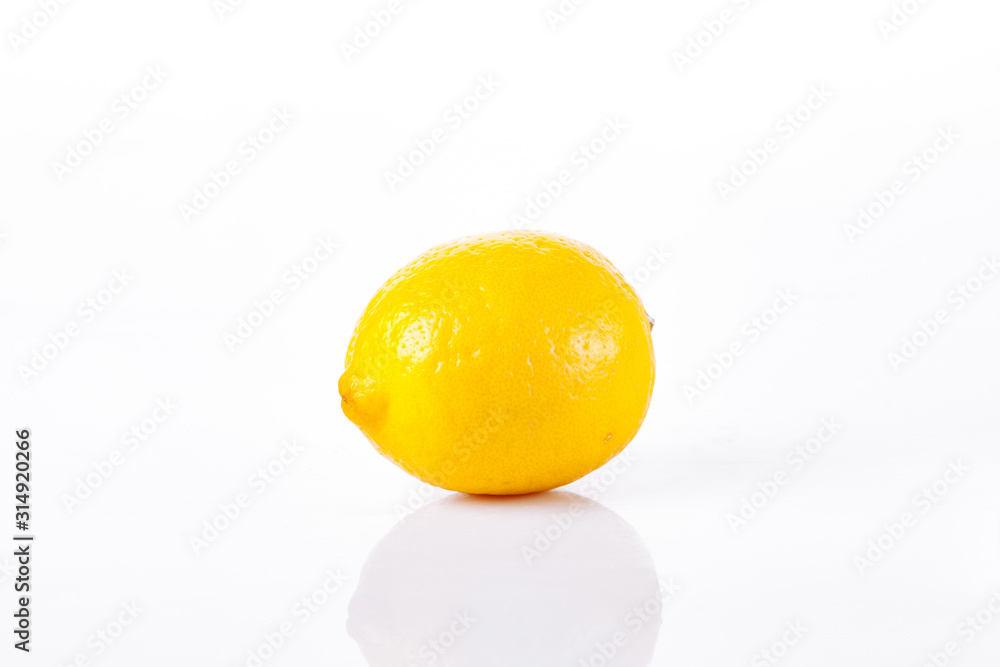 One ripe lemon on a white background One ripe lemon on a white background