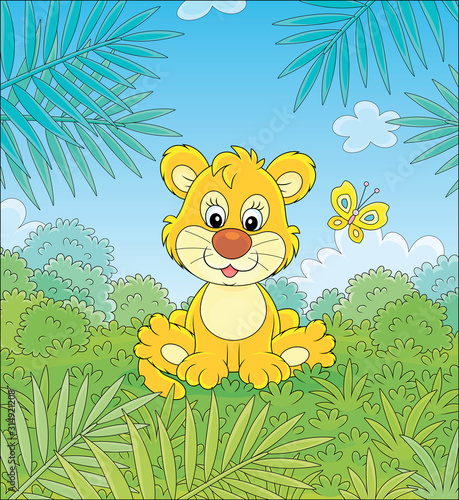 Little lion playing with a small colorful butterfly against the background of palm branches and bushes of savanna  vector cartoon illustration