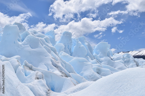 light blue glacier with clouds