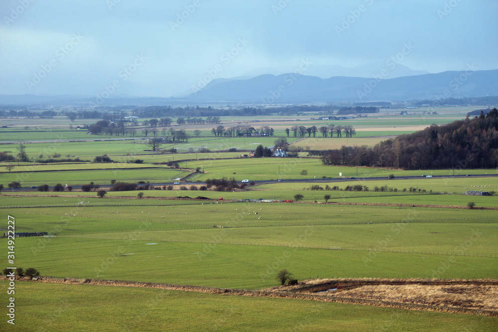 Scottish winter landscape with green fields and mountains. Stirling, Scotland