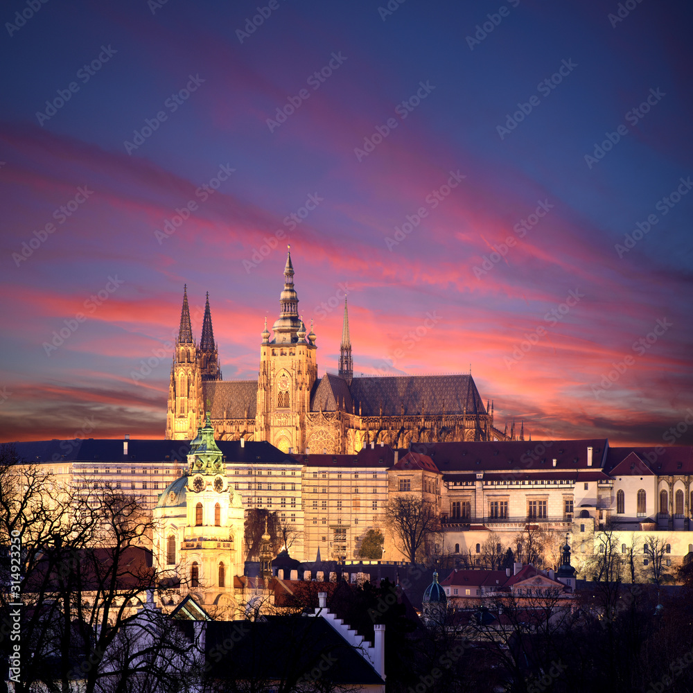 panoramic view To Hradschin Castle, St. Vitus Cathedral And Charles Bridge In Prague, Czech Republic during sunset with dramatic sky
