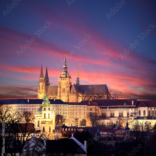 panoramic view To Hradschin Castle, St. Vitus Cathedral And Charles Bridge In Prague, Czech Republic during sunset with dramatic sky