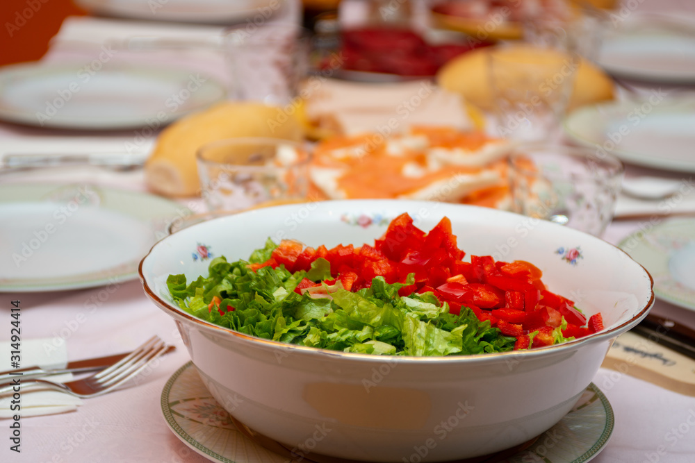 salad bowl in the foreground on a laid table salad bowl in the foreground on a laid table
