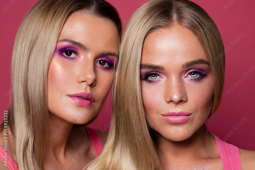 Two beautiful women sisters with makeup and long blonde hair close up portrait Two beautiful women sisters with makeup and long blonde hair close up portrait