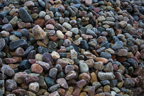 Multi-colored stones in the frost covered with hoarfrost