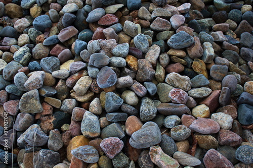 Multi-colored stones in the frost covered with hoarfrost