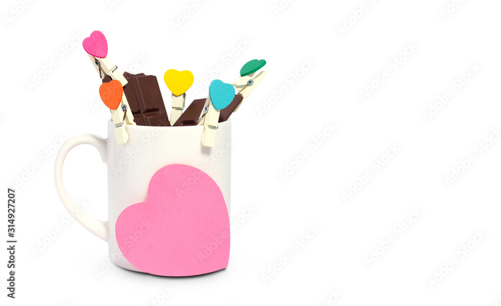 Valentine's day. Chocolate in white coffee cup with small clip heart shape. isolated on white Valentine's day. Chocolate in white coffee cup with small clip heart shape. isolated on white