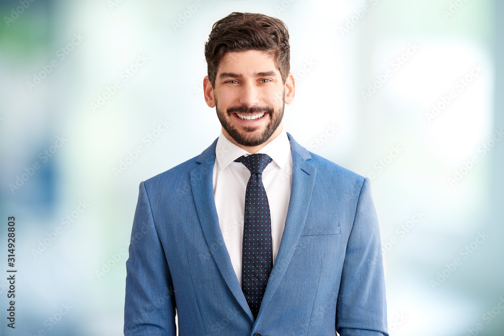 Young businessman standing in the office Young businessman standing in the office