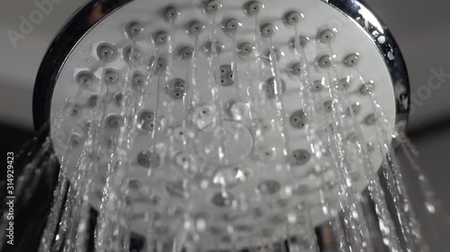 Slow motion shot of shower head with flowing water