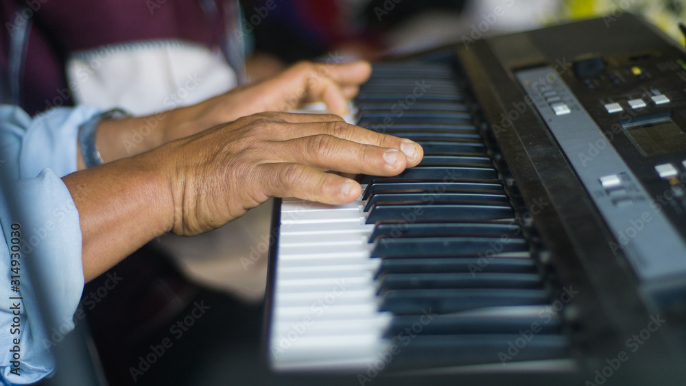 Obraz premium The finger that is pressing the piano playing