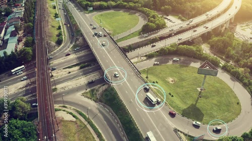 Autonomous Self Driving Cars Concept. Aerial view of cars and buses moving on city intersection and Artificial Intelligence scans road with sensors and control vehicles in traffic. Future