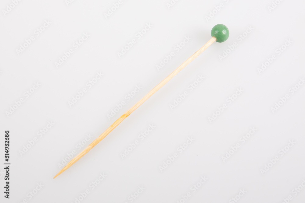 Natural wooden toothpicks green ball isolated on white background Natural wooden toothpicks green ball isolated on white background