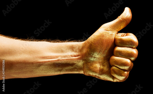 Image of gold painted Like gesture on black background