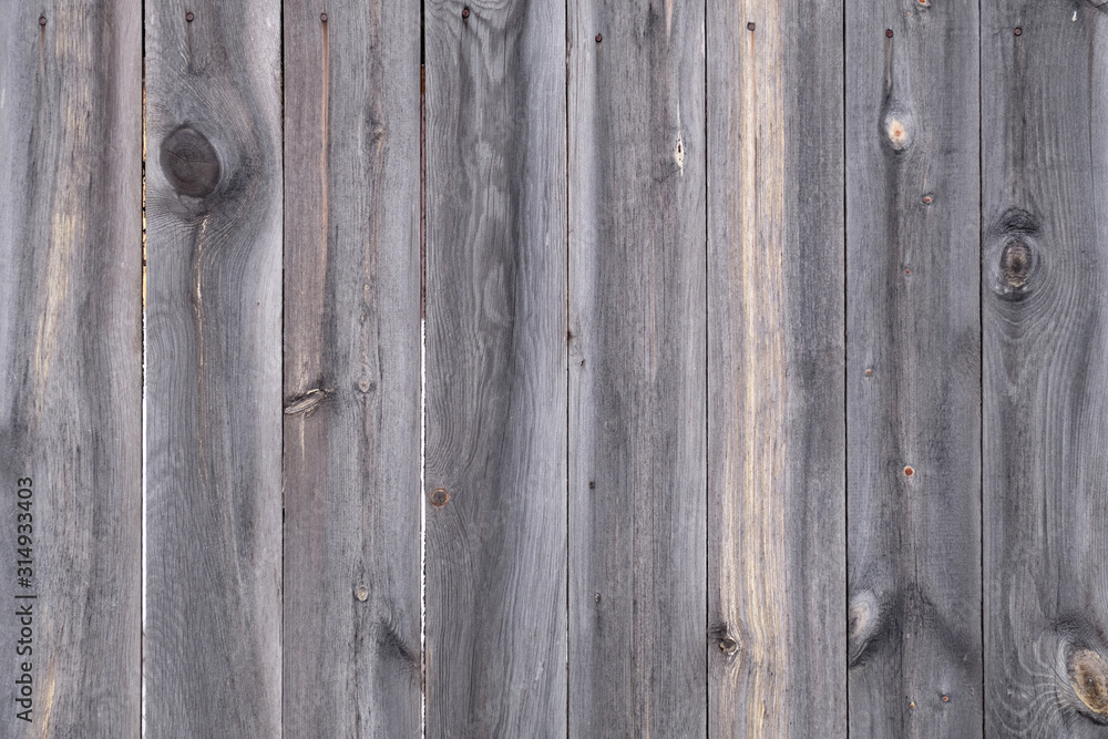 Old village fence, wooden background texture with knots and nail holes Old village fence, wooden background texture with knots and nail holes