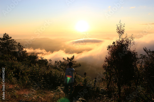 Beautiful scenery of mountain with mist sea, golden light shines on sky and sunrise up from the horizon at view point of Phu chi phoe in the early morning, Khun Yuam, Mae Hong Son, Thailand