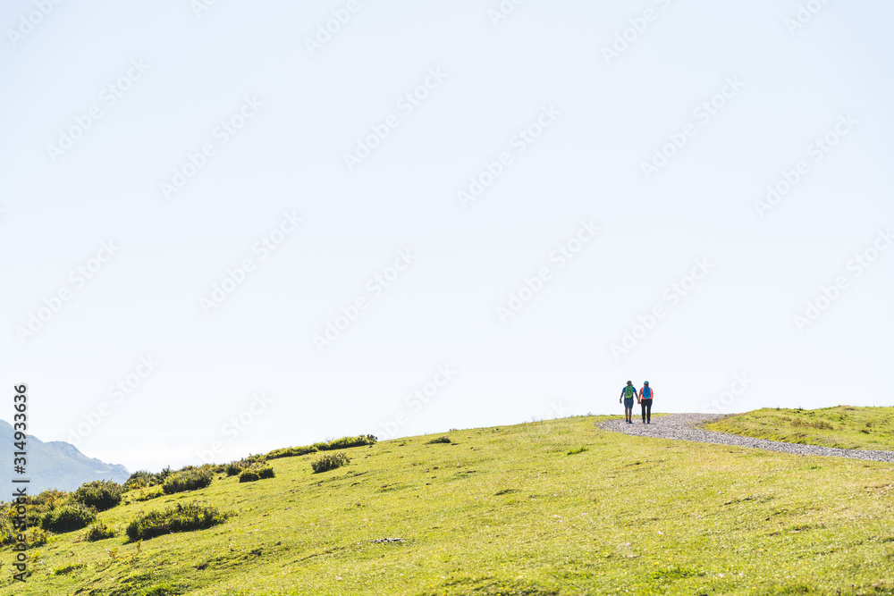Couple Hiking in the Mountain Wearing Backpack.