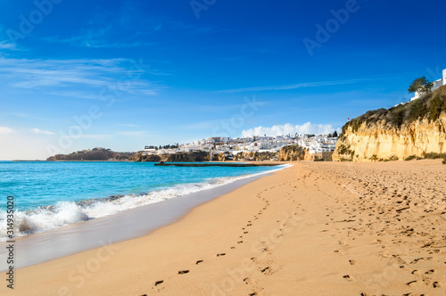Sandy beach in Albufeira resort village in Algarve, Portugal.