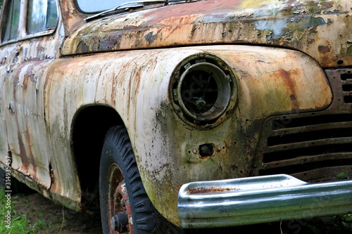 Rusty vintage car on the junkyard