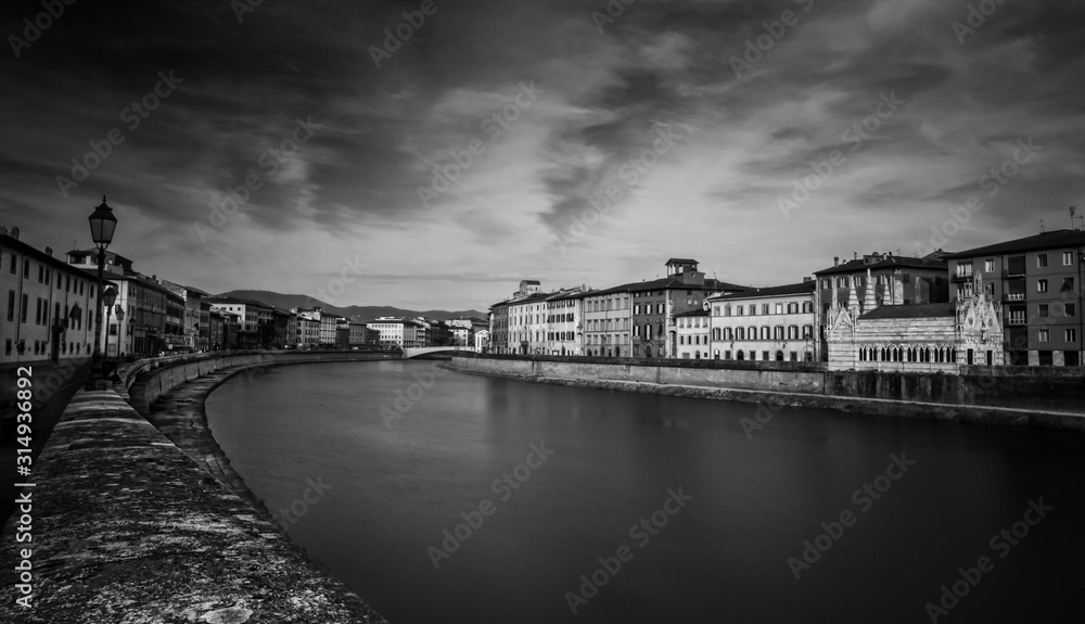 Ancient buildings along Arno river - black and white