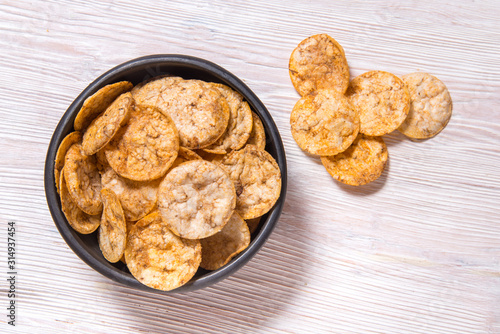 Fotografie Top view pile of organic, crispy, baked, whole grain rice chips with spices