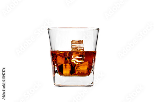 Glass of whiskey with ice or brandy isolated on a white background. Whiskey with ice in a glass against a white background.
