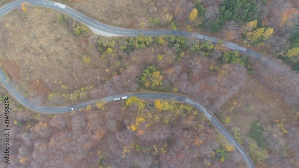 Drone follows white truck with cargo on asphalt road Drone follows white truck with cargo on asphalt road