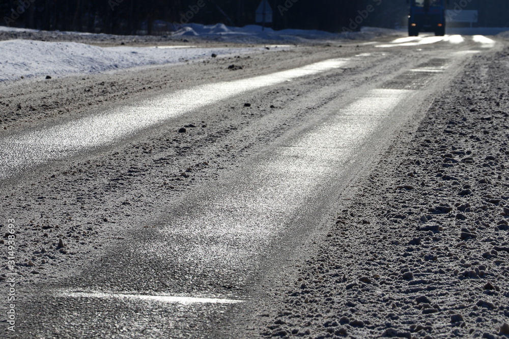 De-icing chemicals and sand on the winter road. De-icing chemicals and sand on the winter road.