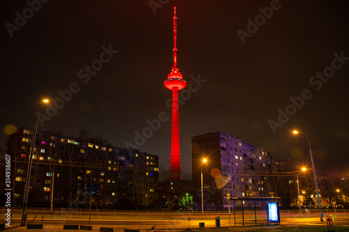 Vilnius TV Tower, Lithuania colored with red light, night with soviet buildings