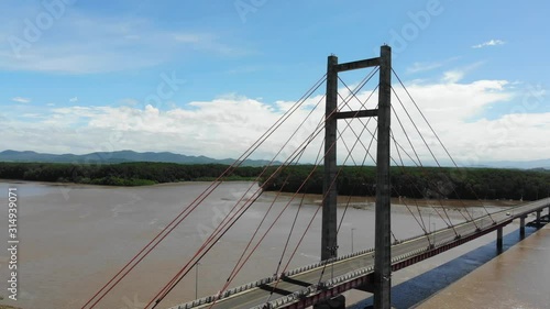 Aerial shot of the Puente de La Amistad de Taiwán (Taiwan friendship bridge). Flying backwards at west side of bridge, with Palo Verde NP in background. Guanacaste, Costa Rica. photo
